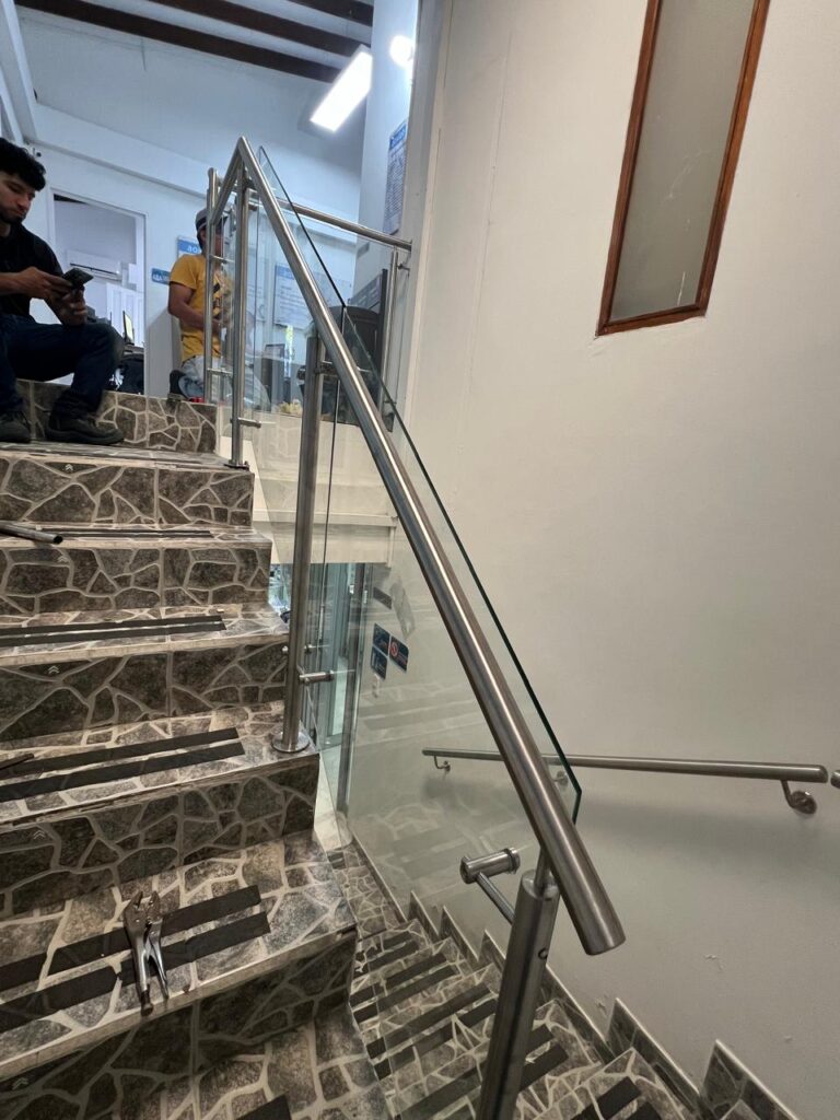 Baranda en acero inoxidable y vidrio templado en escalera de edificio